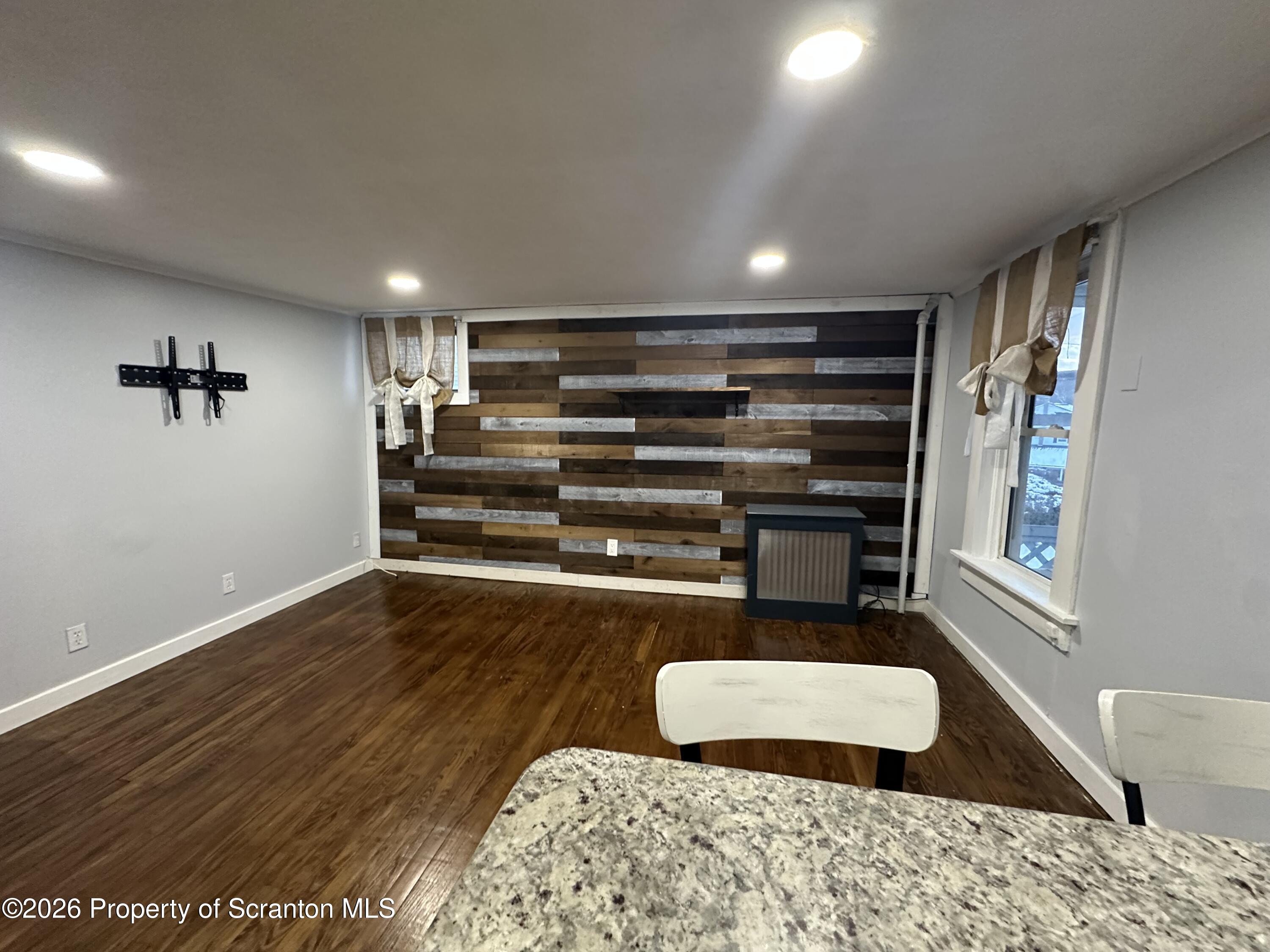 611 Chestnut Street Dunmore, PA 18512 - Photo 10 of 27 a room with wooden floors and furniture