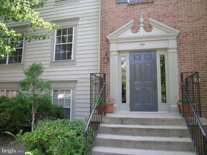 131 Fort Evans Road Southeast, Unit C Leesburg, VA 20175 - Photo 1 of 13 a front view of a house with a garden and plants