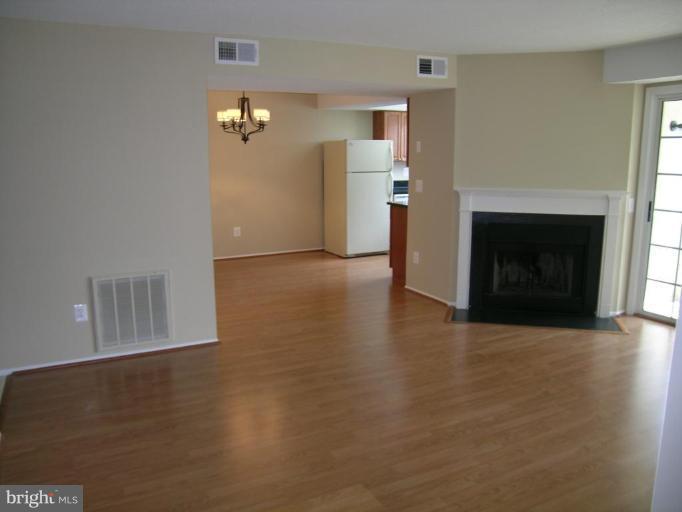 131 Fort Evans Road Southeast, Unit C Leesburg, VA 20175 - Photo 12 of 13 a view of a livingroom with wooden floor and a fireplace