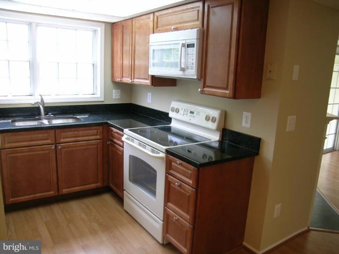 131 Fort Evans Road Southeast, Unit C Leesburg, VA 20175 - Photo 13 of 13 a kitchen with granite countertop a sink and a stove