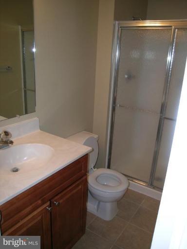 131 Fort Evans Road Southeast, Unit C Leesburg, VA 20175 - Photo 4 of 13 a bathroom with a sink a toilet and shower