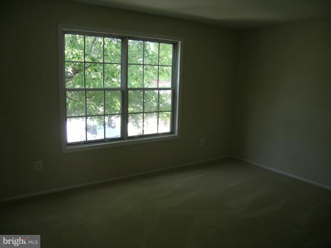 131 Fort Evans Road Southeast, Unit C Leesburg, VA 20175 - Photo 5 of 13 an empty room with a window