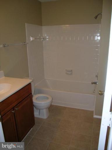 131 Fort Evans Road Southeast, Unit C Leesburg, VA 20175 - Photo 6 of 13 a bathroom with a sink a toilet and shower