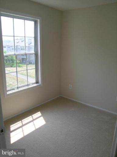 131 Fort Evans Road Southeast, Unit C Leesburg, VA 20175 - Photo 8 of 13 an empty room with a window
