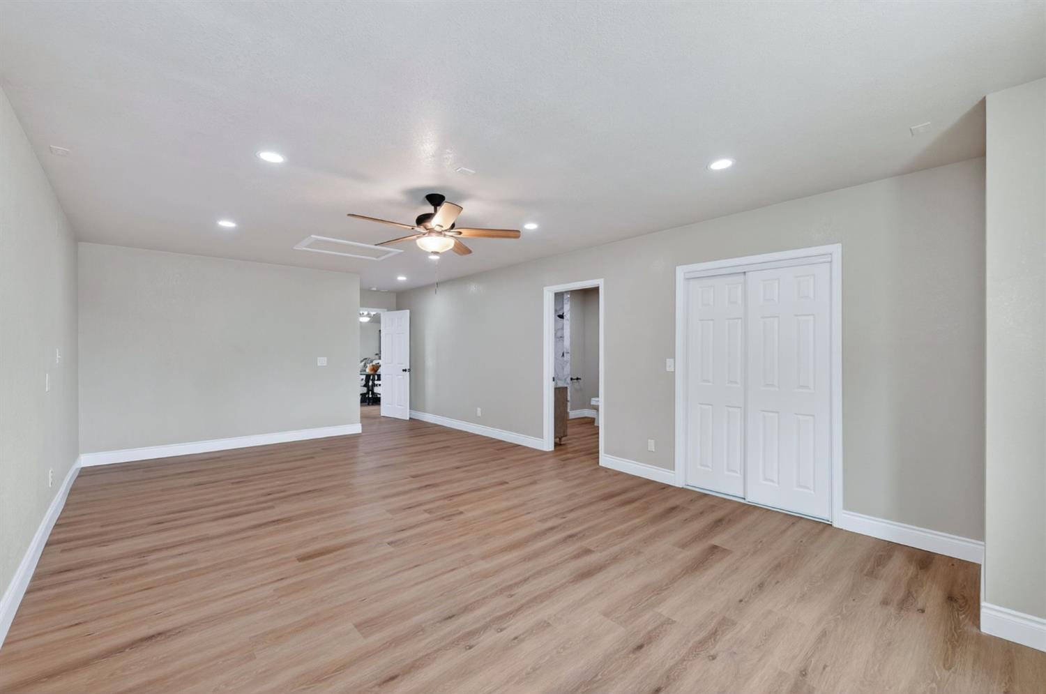 16564 Monreal Road Madera, CA 93636 - Photo 50 of 59 a view of an empty room with wooden floor