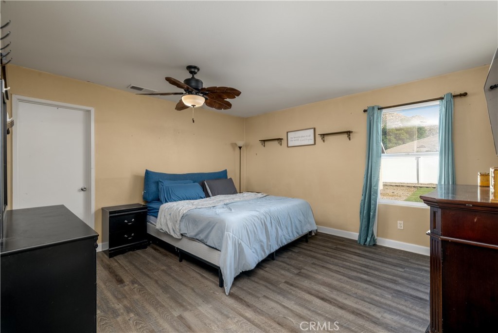 3079 Avalon Parkway Perris, CA 92571 - Photo 11 of 25 a bedroom with a bed and wooden floor
