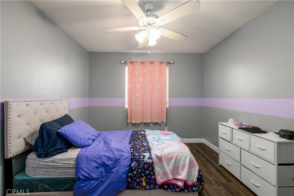 3079 Avalon Parkway Perris, CA 92571 - Photo 15 of 25 a bedroom with a bed and a chandelier