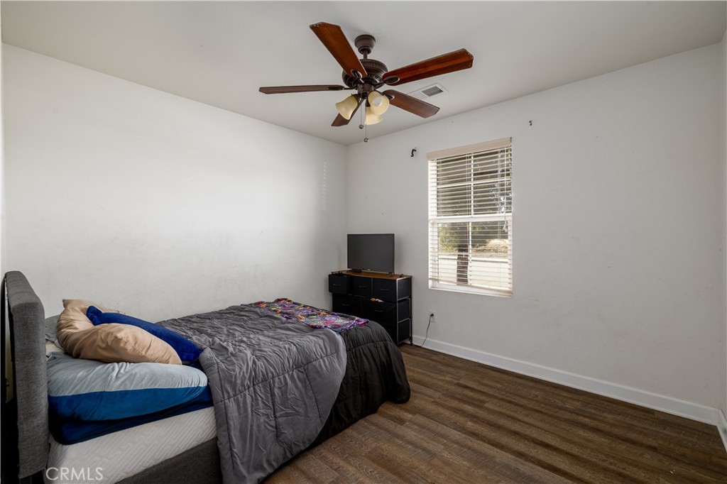 3079 Avalon Parkway Perris, CA 92571 - Photo 16 of 25 a bedroom with a bed and a window