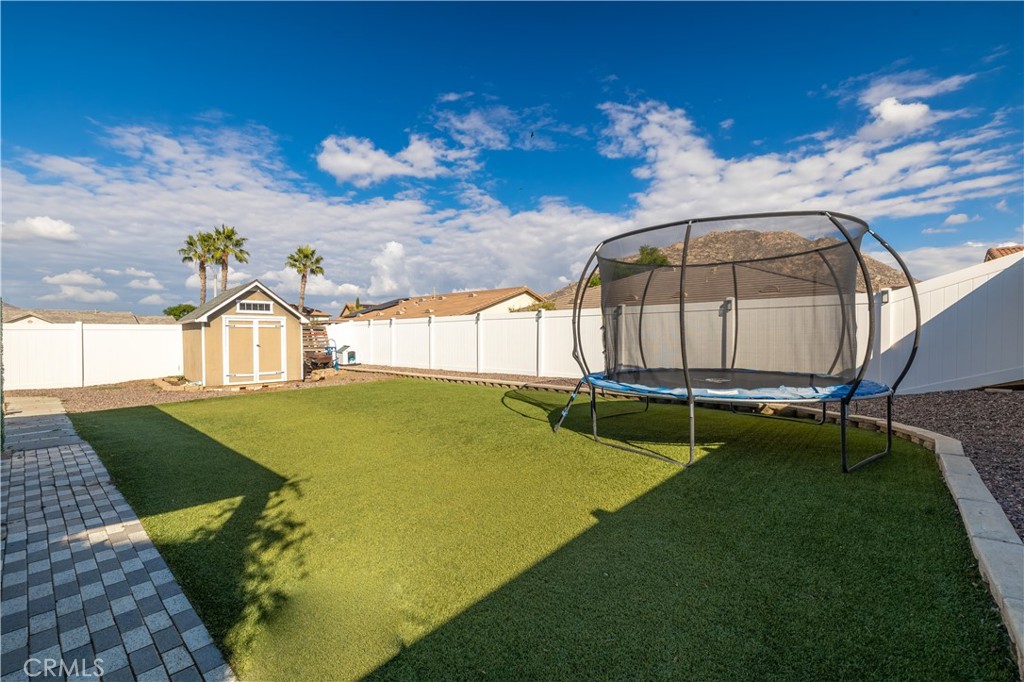 3079 Avalon Parkway Perris, CA 92571 - Photo 20 of 25 a view of a swimming pool with a yard and seating area