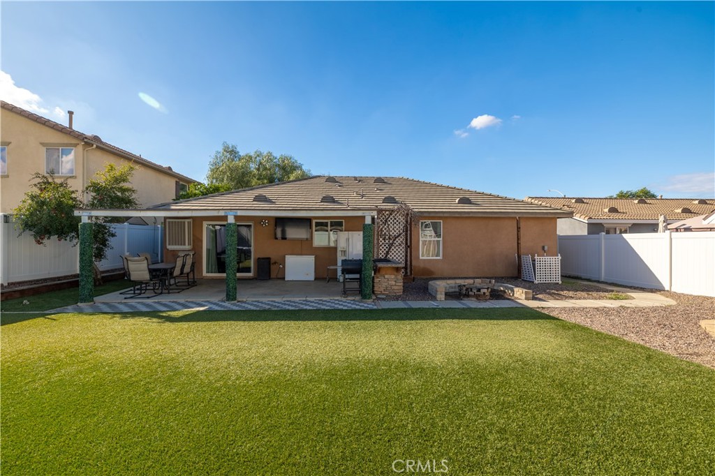 3079 Avalon Parkway Perris, CA 92571 - Photo 22 of 25 a view of a house with a yard and sitting area
