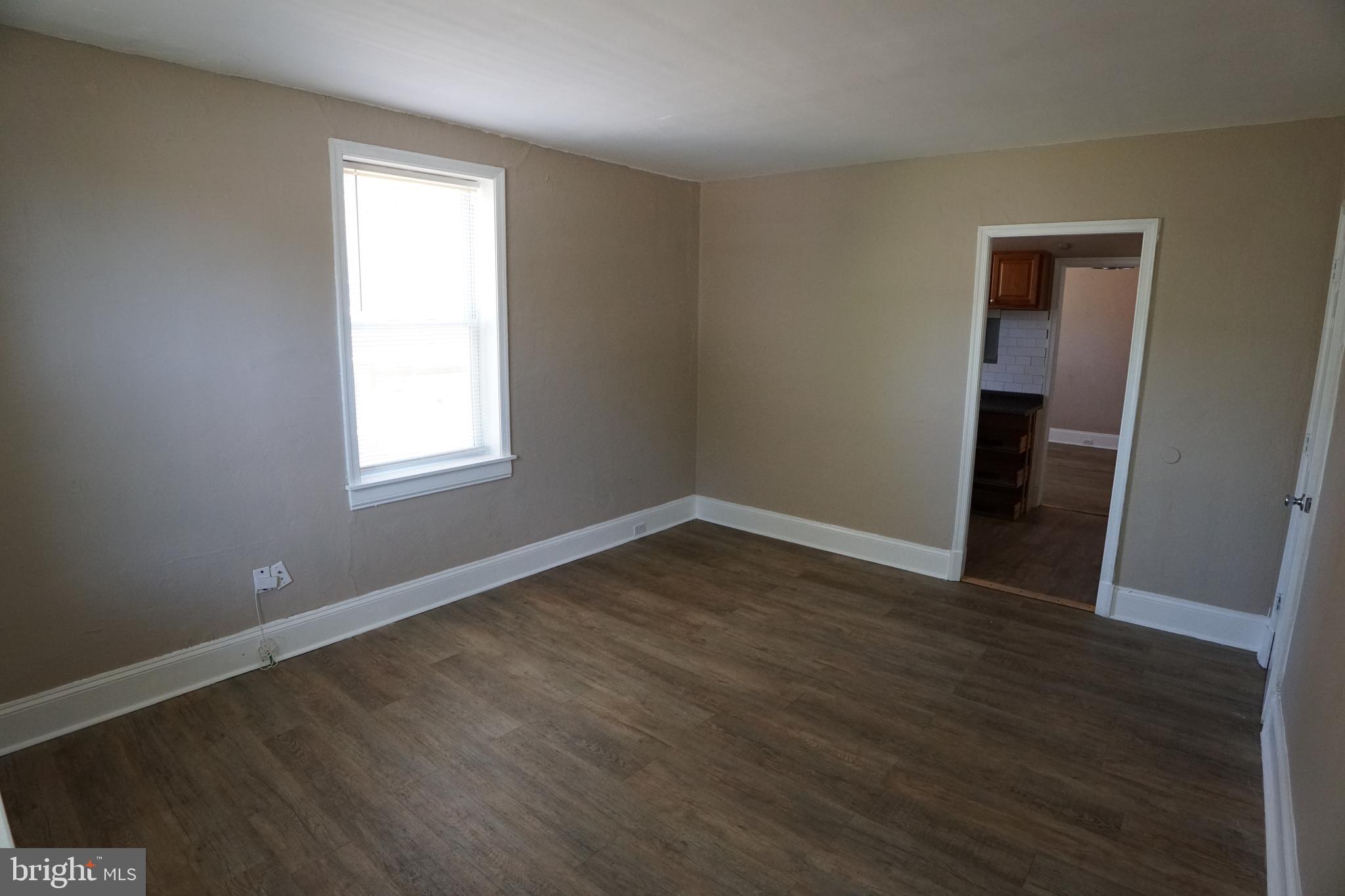 2 Aigburth Road, Unit 1 Towson, MD 21286 - Photo 4 of 10 an empty room with wooden floor and windows