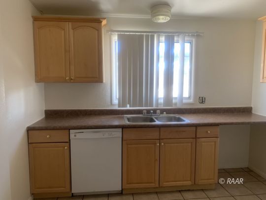 220 Palm Drive Ridgecrest, CA 93555 - Photo 4 of 9 a kitchen with a sink and cabinets