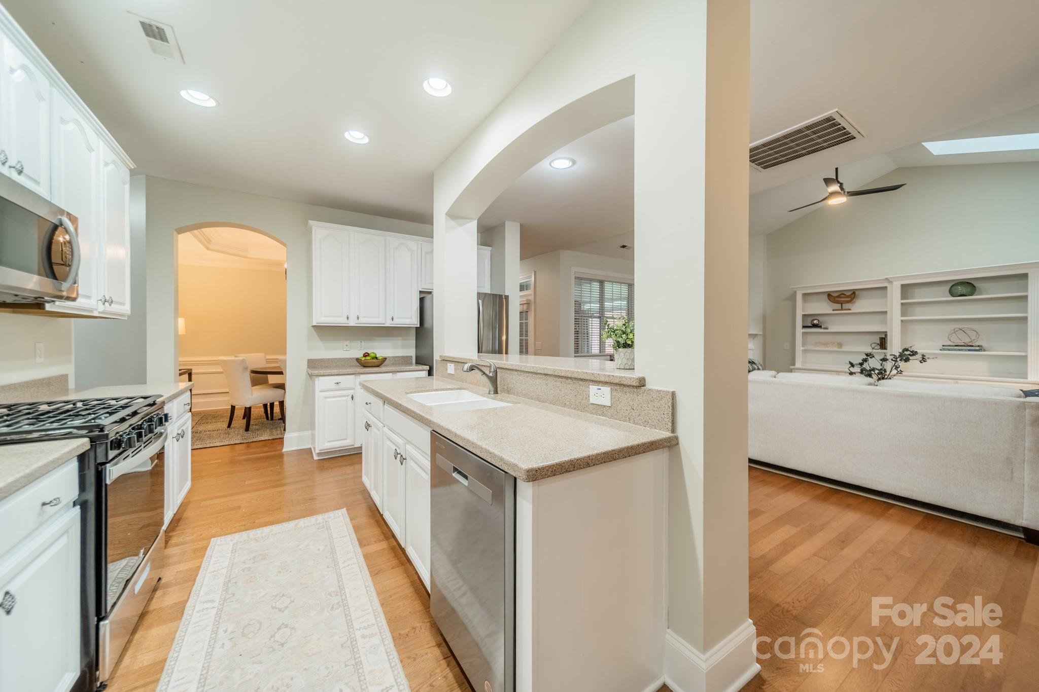10806 Round Rock Road Charlotte, NC 28277 - Photo 17 of 41 a large kitchen with stainless steel appliances granite countertop a lot of counter space and wooden floor