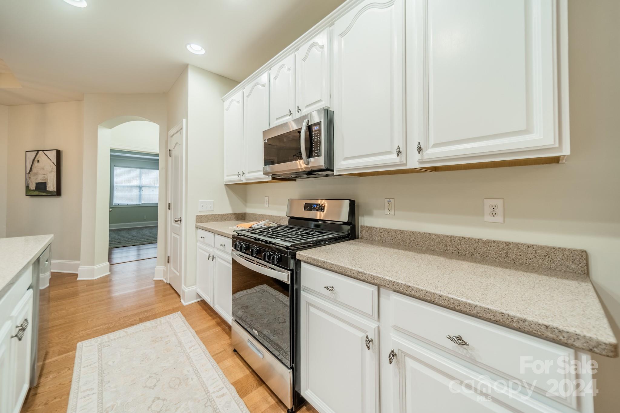 10806 Round Rock Road Charlotte, NC 28277 - Photo 18 of 41 a kitchen with stainless steel appliances granite countertop a stove a sink and a microwave