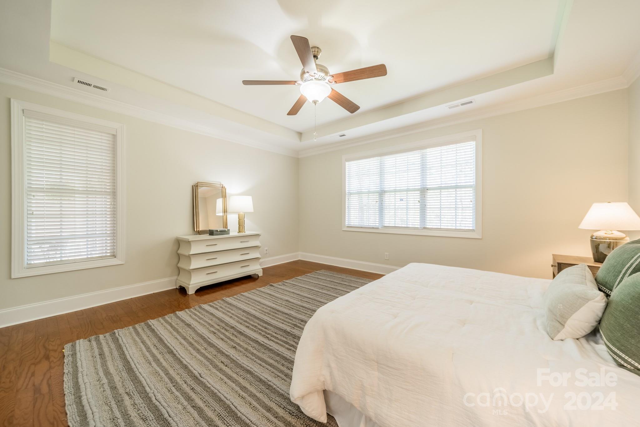 10806 Round Rock Road Charlotte, NC 28277 - Photo 22 of 41 a bedroom with a bed and wooden floor