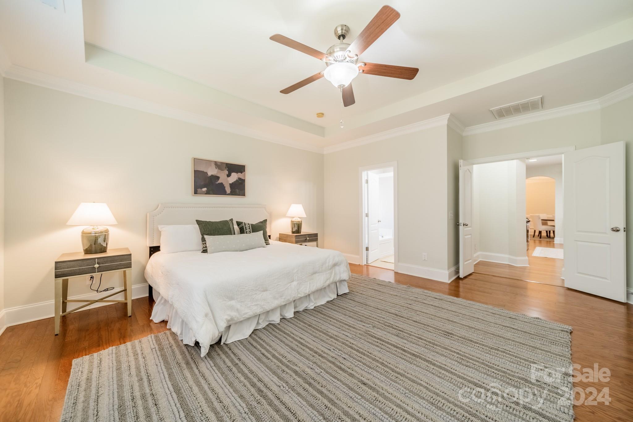 10806 Round Rock Road Charlotte, NC 28277 - Photo 23 of 41 a spacious bedroom with a bed and a chandelier