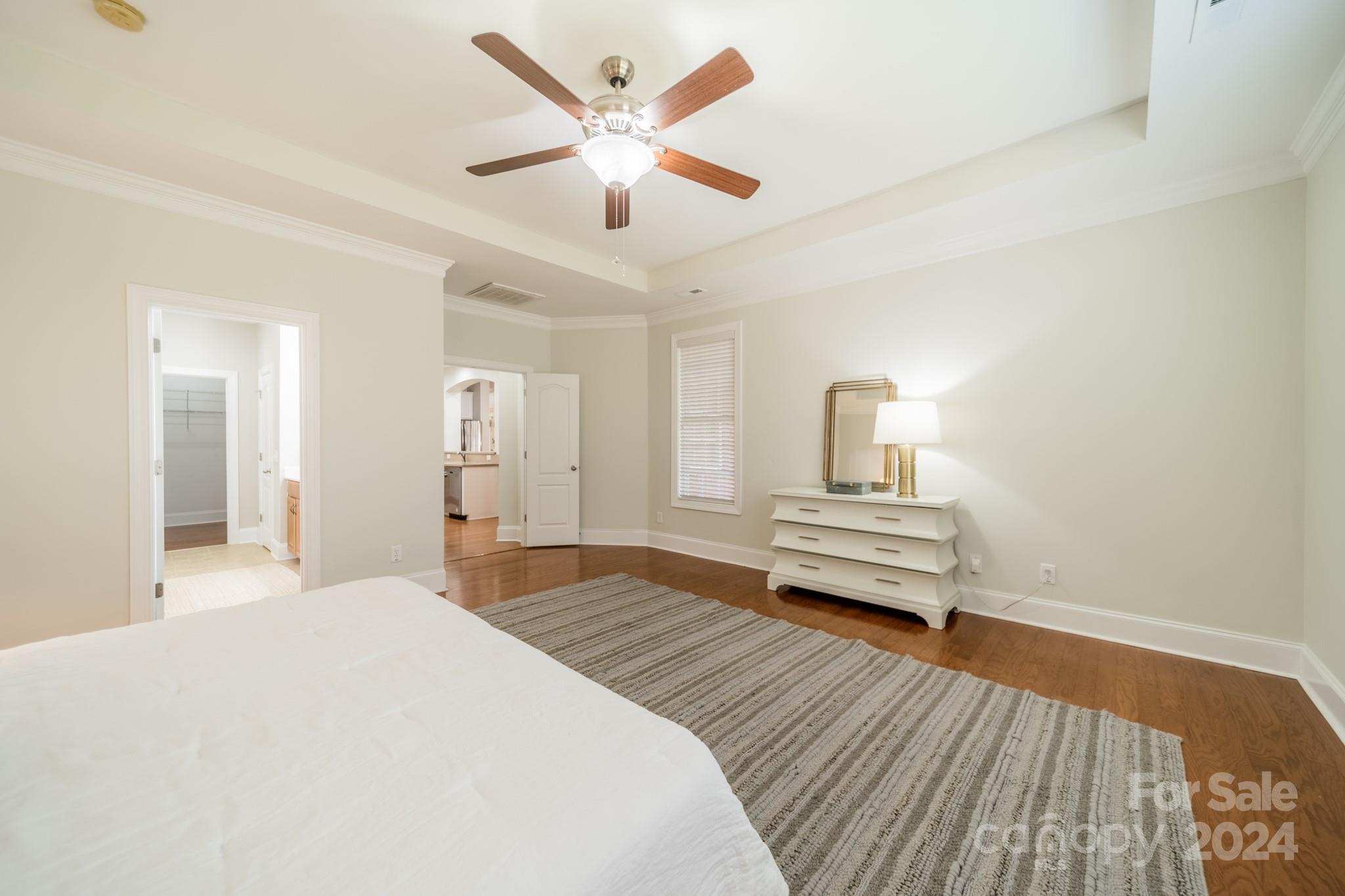 10806 Round Rock Road Charlotte, NC 28277 - Photo 24 of 41 a bedroom with a bed wooden floor and a ceiling fan