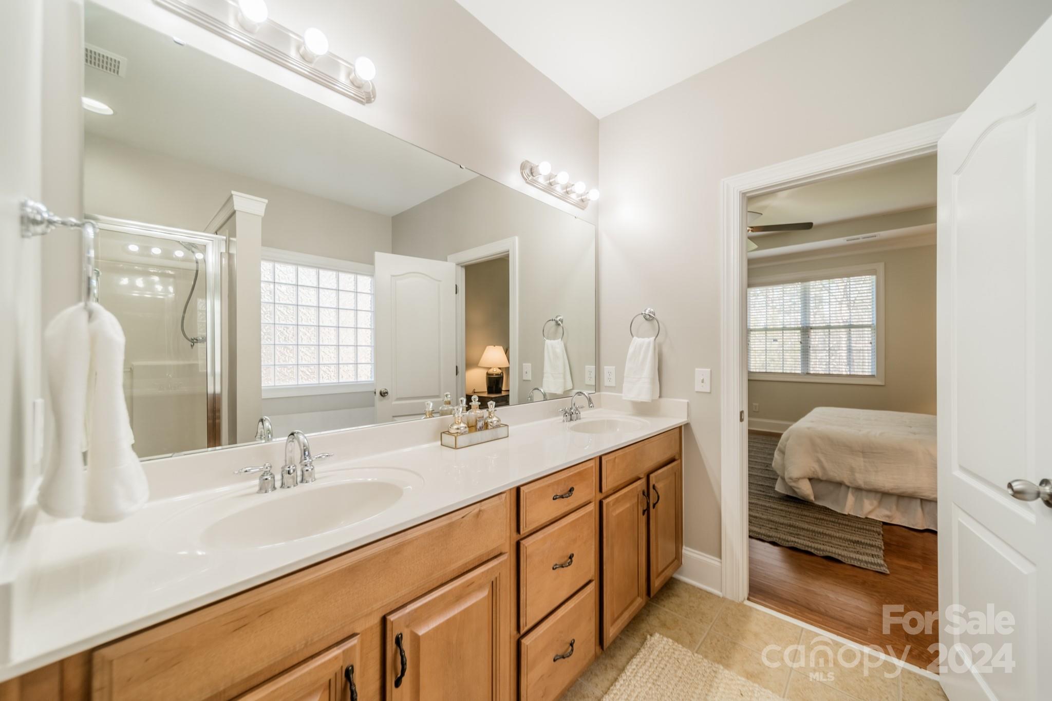 10806 Round Rock Road Charlotte, NC 28277 - Photo 25 of 41 a en suite bathroom with double vanity and a mirror