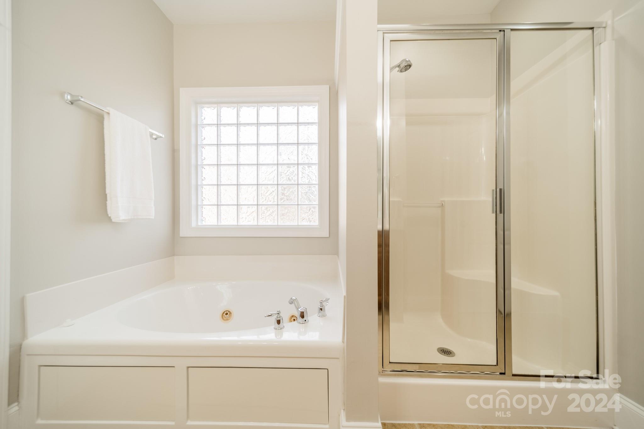 10806 Round Rock Road Charlotte, NC 28277 - Photo 26 of 41 a bathroom with a bathtub and a shower