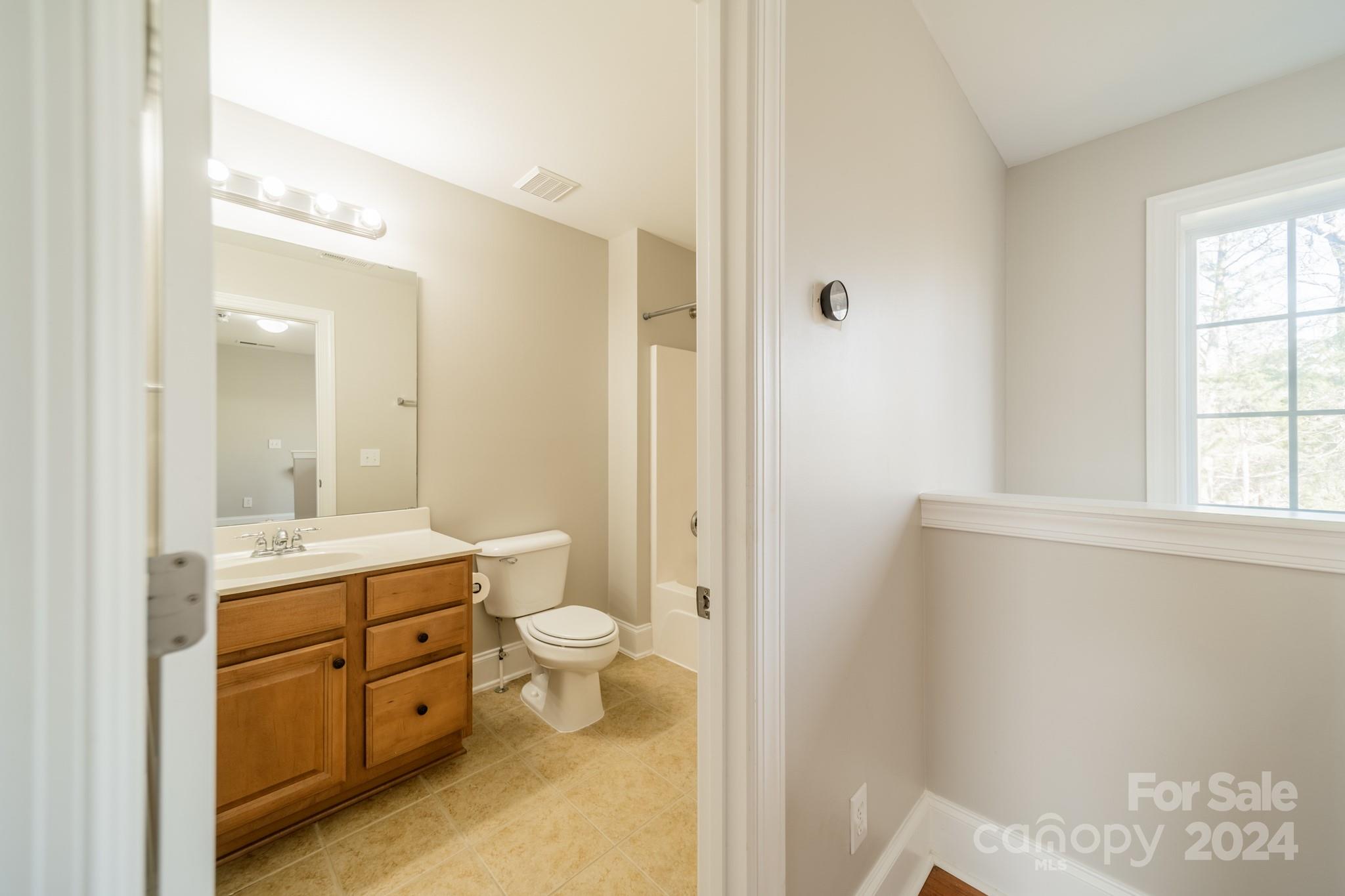 10806 Round Rock Road Charlotte, NC 28277 - Photo 33 of 41 a bathroom with a granite countertop sink toilet a large mirror a shower and vanity