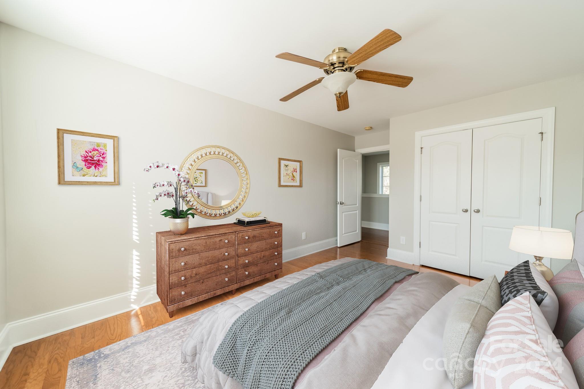 10806 Round Rock Road Charlotte, NC 28277 - Photo 35 of 41 a bed room with a bed and a chandelier