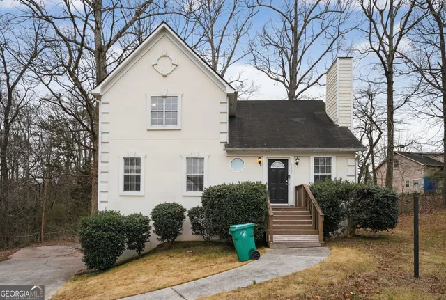 a front view of a house with garden