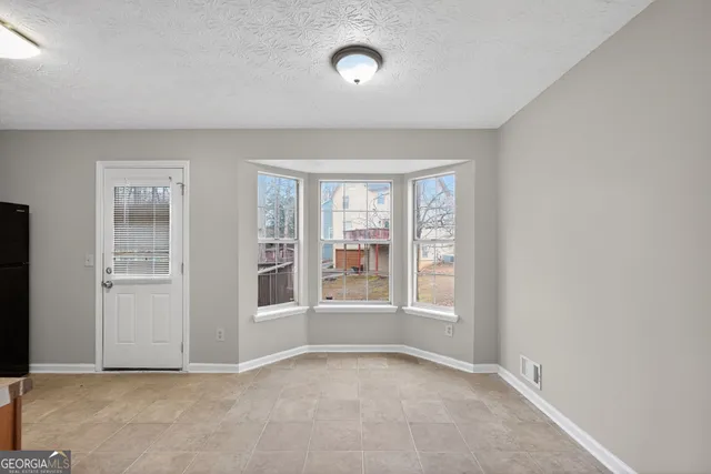 an empty room with windows and entrance