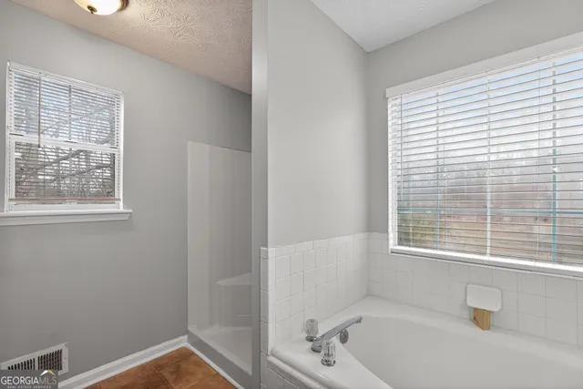 a bath room with a window and a shower