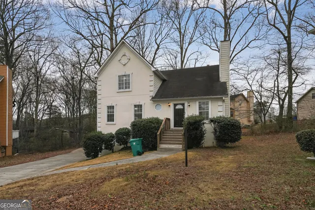 a house that has a tree in front of it