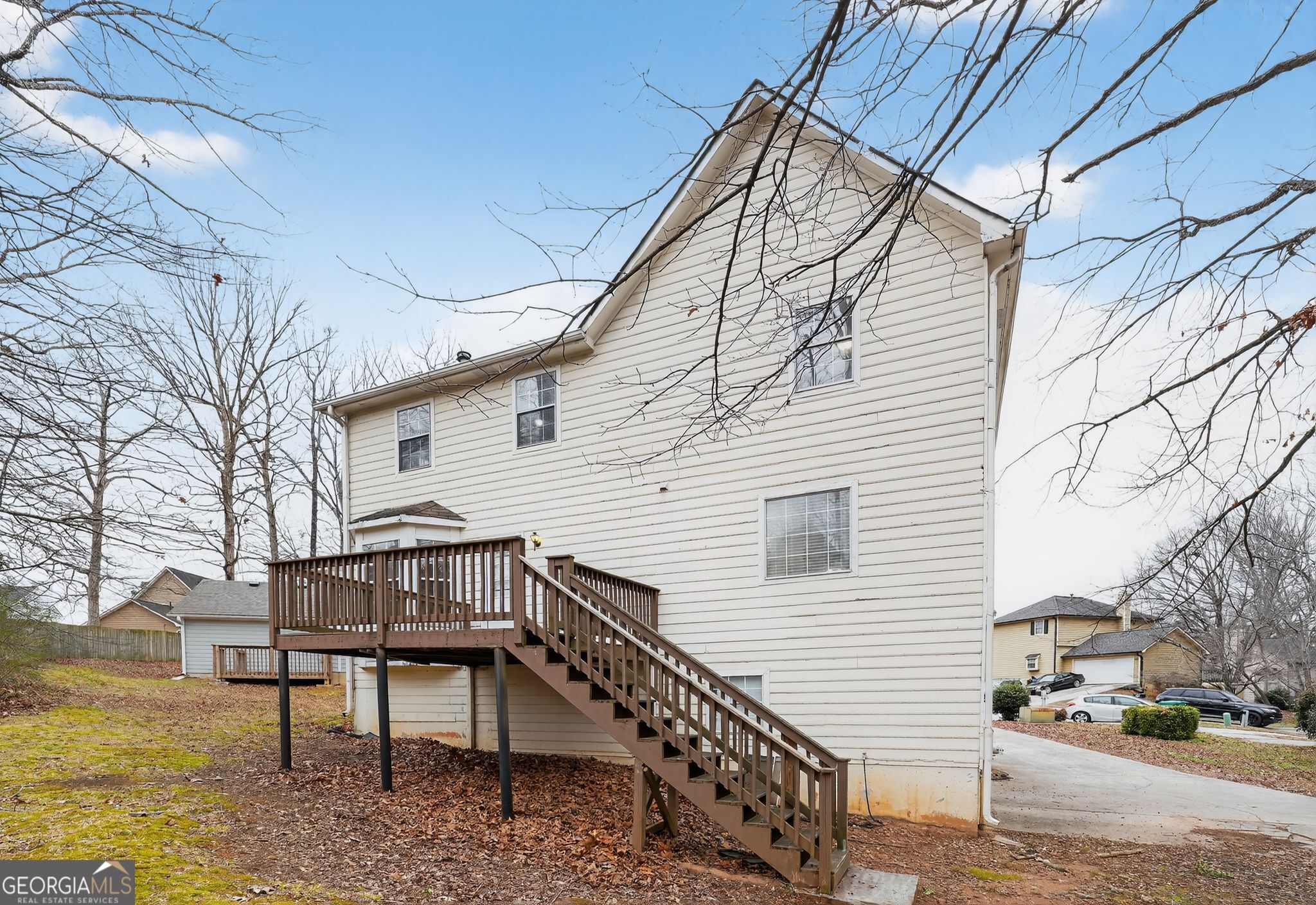 5207 Oaktree Court Lithonia, GA 30038 - Photo 36 of 39 a view of a house with a bench next to a yard