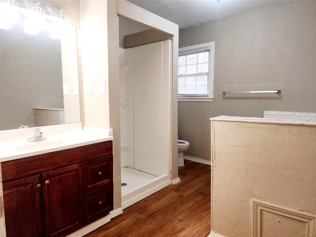 739 South Andrews Avenue Sherman, TX 75090 - Photo 2 of 15 a bathroom with a sink a toilet and a window