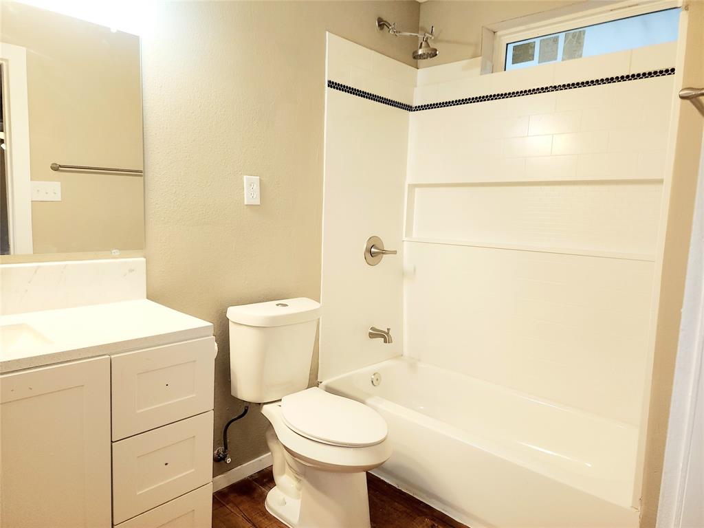 739 South Andrews Avenue Sherman, TX 75090 - Photo 3 of 15 a bathroom with a sink a toilet and shower