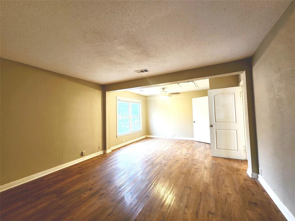 739 South Andrews Avenue Sherman, TX 75090 - Photo 5 of 15 a view of an empty room with wooden floor and a window
