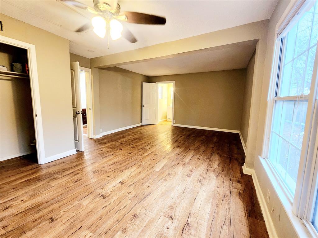 739 South Andrews Avenue Sherman, TX 75090 - Photo 6 of 15 wooden floor in an empty room with a window