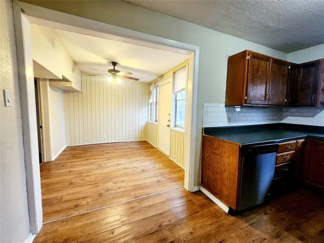 a view of kitchen with wooden floor and a sink