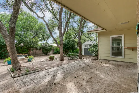 a view of a house with backyard and sitting area