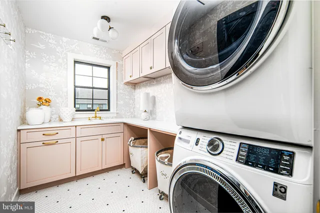 a utility room with sink dryer and washer