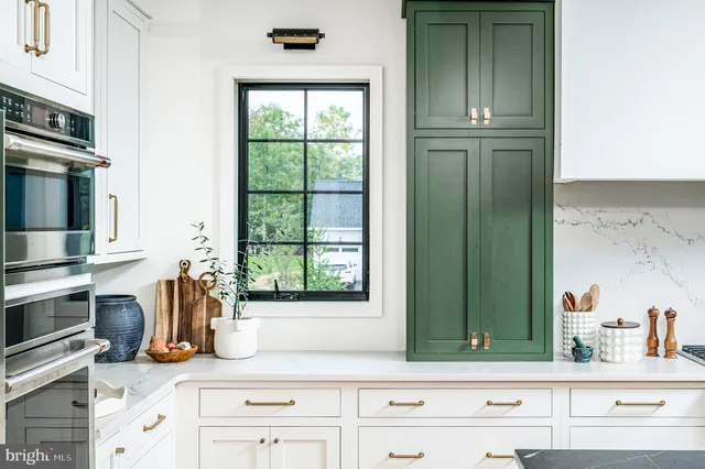a kitchen with window and cabinets