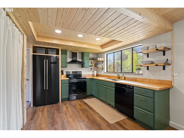 a kitchen with stainless steel appliances granite countertop a refrigerator and a sink