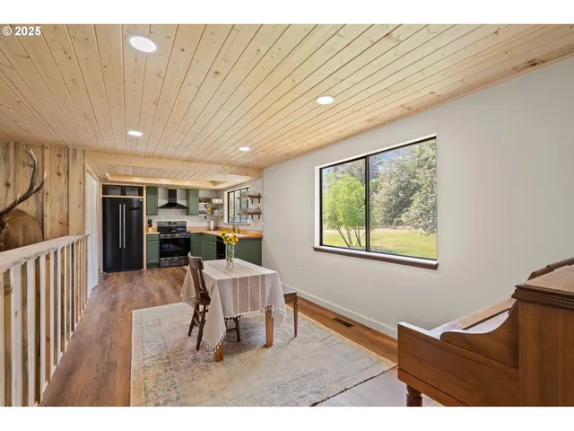 a dining room with furniture and a window