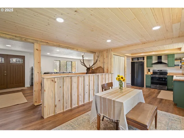 a living room with furniture a flat screen tv and a large window