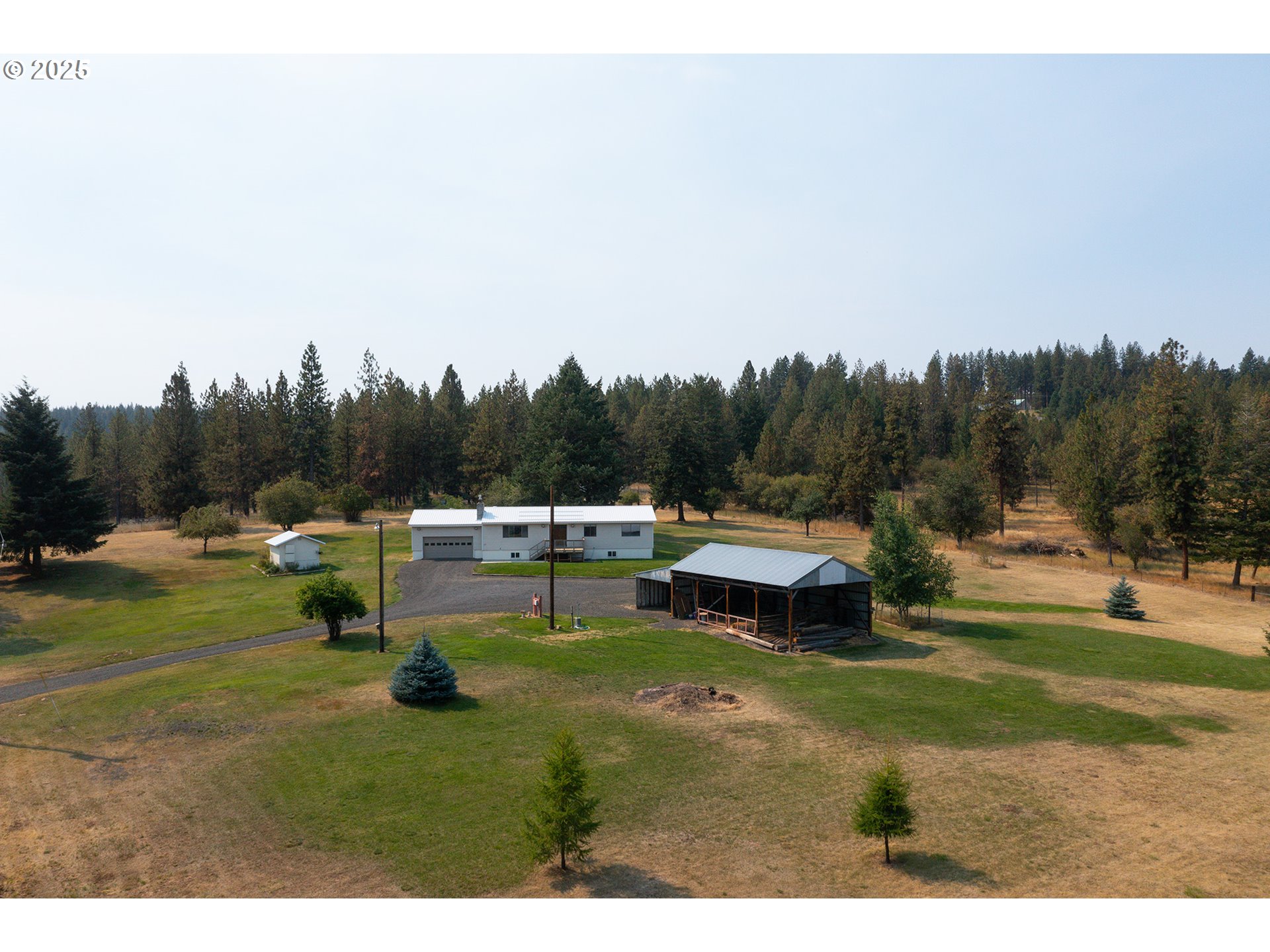 49414 County 1028 Road Pendleton, OR 97801 - Photo 6 of 46 a backyard of a house with table and chairs