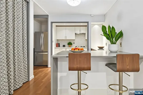 a dining room with furniture and wooden floor