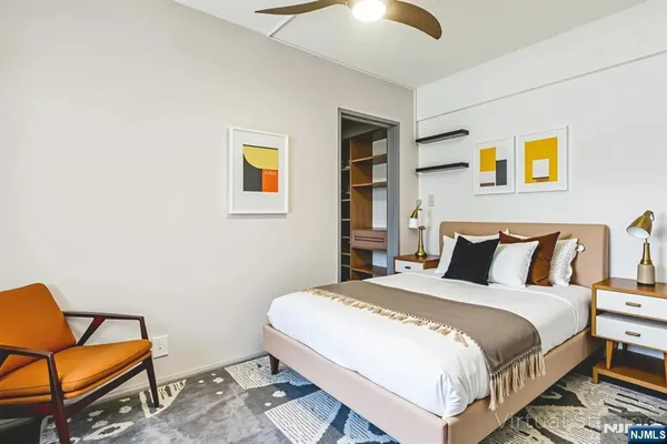 a bedroom with a bed and chair