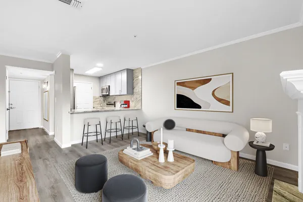 a living room with furniture and a wooden floor