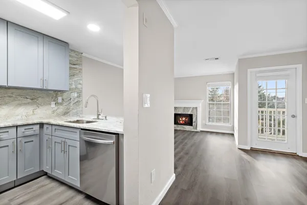 a kitchen with a sink cabinets and wooden floor