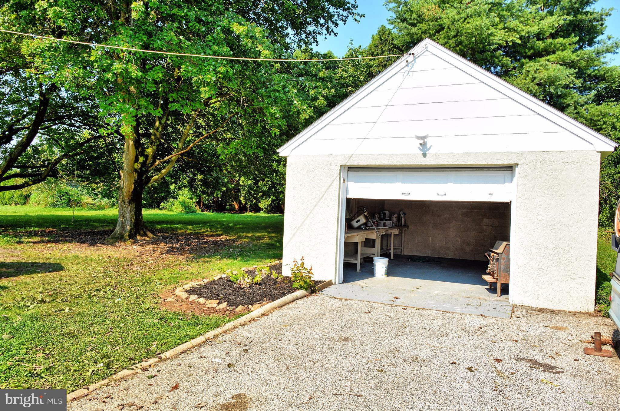 12408 Regwood Road Hydes, MD 21082 - Photo 17 of 17 a view of a house with a yard and garage
