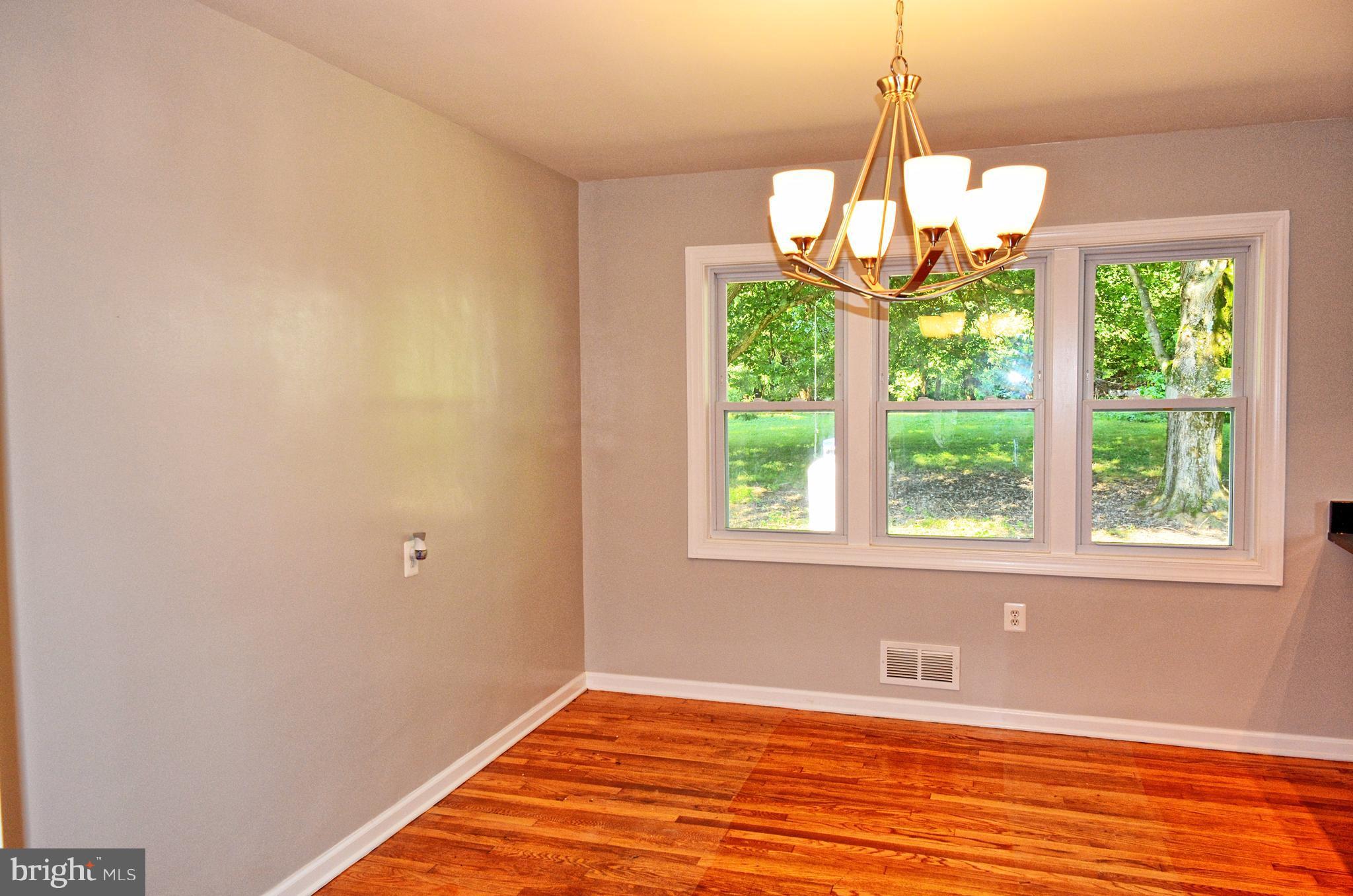 12408 Regwood Road Hydes, MD 21082 - Photo 6 of 17 a view of an empty room with wooden floor and a window