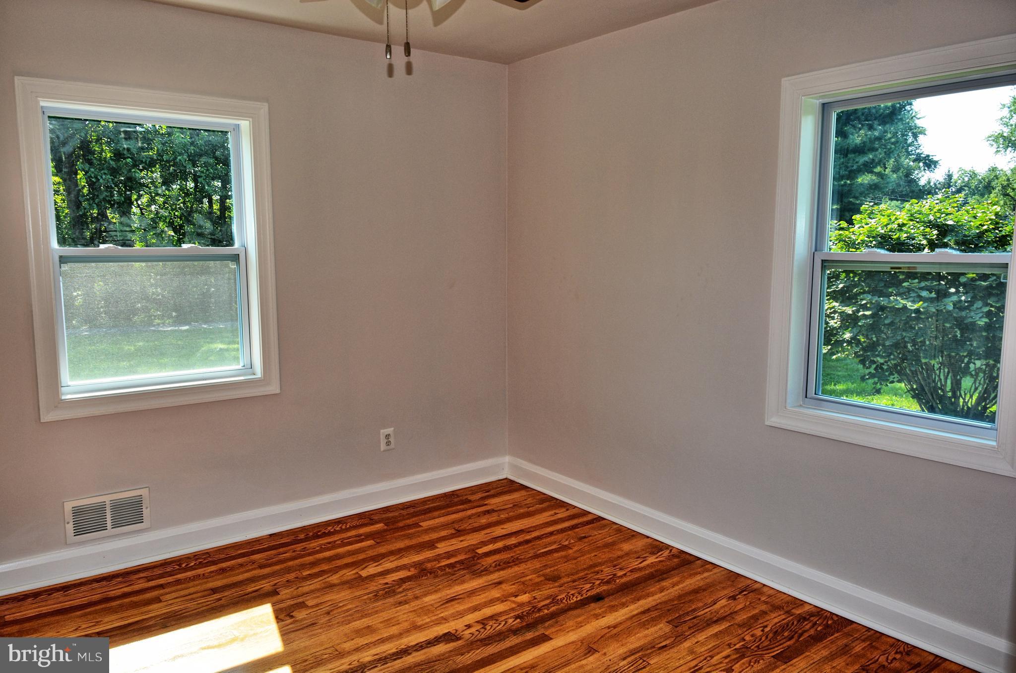 12408 Regwood Road Hydes, MD 21082 - Photo 8 of 17 a view of empty room with wooden floor and fan