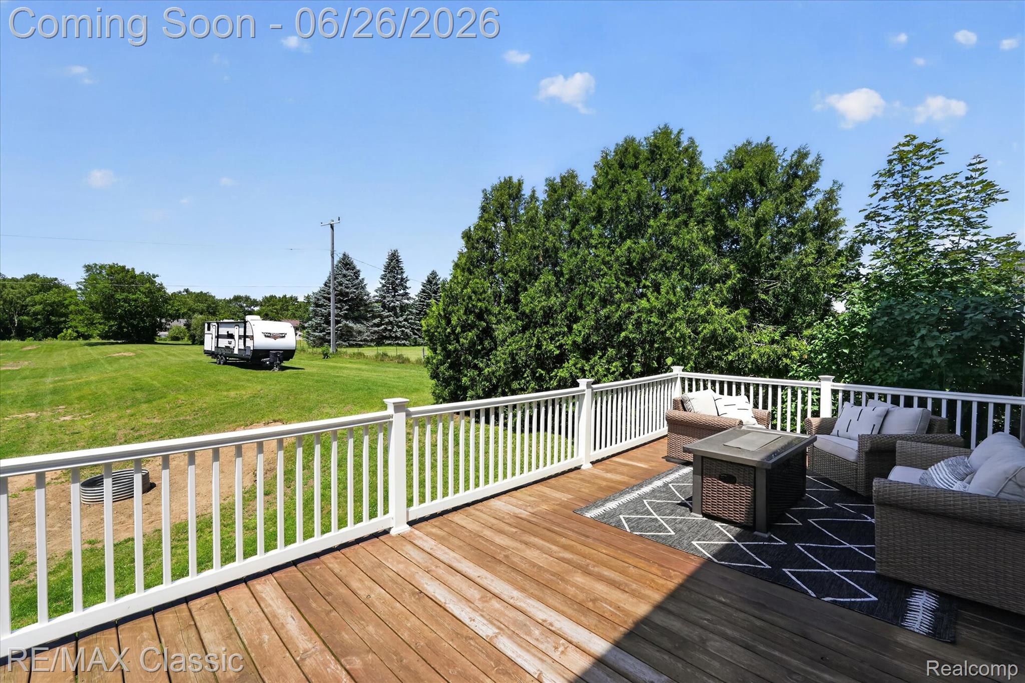 3205 North Milford Road Highland, MI 48357 - Photo 41 of 53 Expansive wood deck featuring white baluster railings and a large outdoor rug